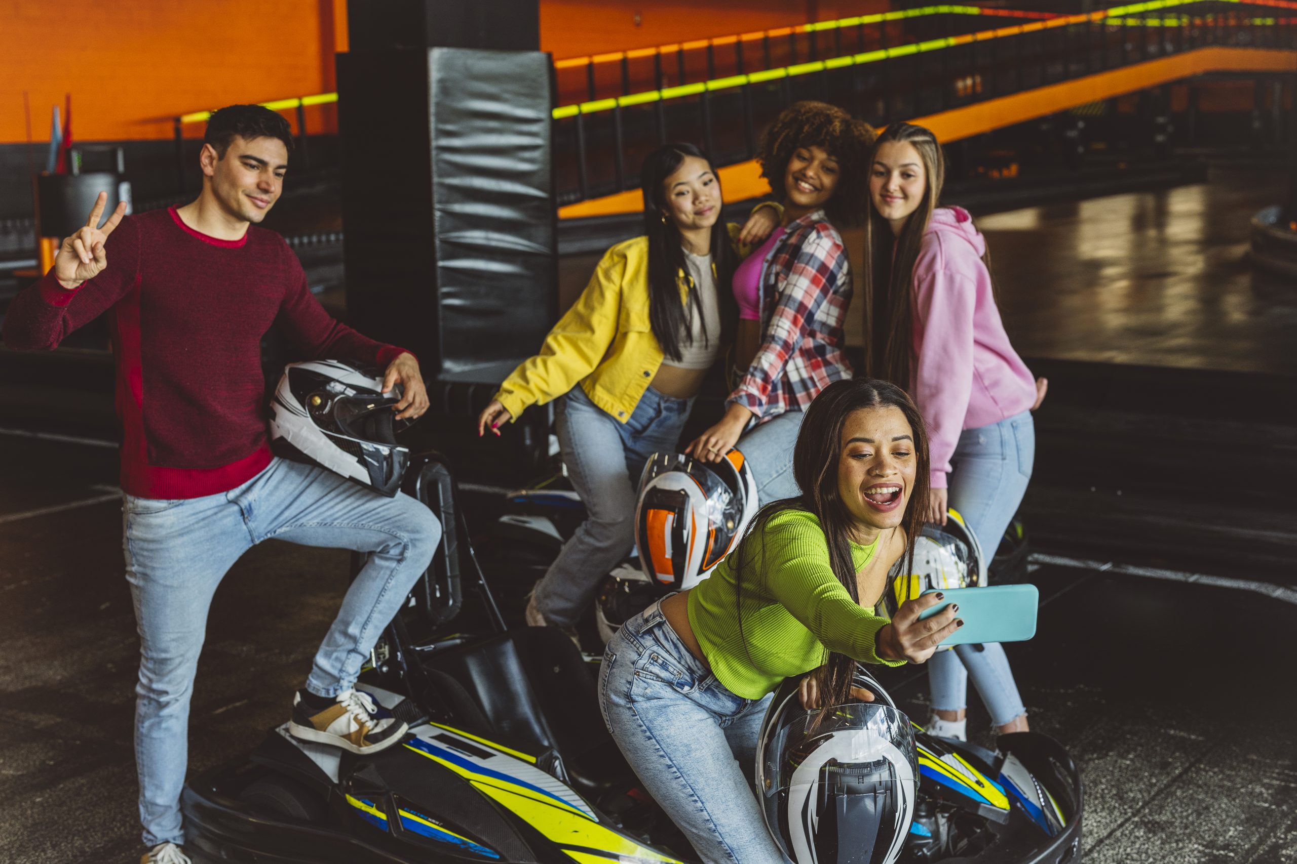 group of multiracial teenage friends taking a selfie with the ph